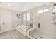 Bright bathroom featuring a soaking tub, glass-enclosed shower, and modern fixtures at 352 Dandelion Brook Ct, Las Vegas, NV 89148