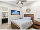 Cozy bedroom with wood-look flooring, a beach-themed photo and a wooden frame bed at 352 Dandelion Brook Ct, Las Vegas, NV 89148