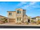 Inviting two-story home featuring a neutral exterior, well-kept landscaping, and a brick-paved driveway at 352 Dandelion Brook Ct, Las Vegas, NV 89148