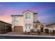 Charming two-story home with a neutral exterior, complemented by manicured landscaping and a brick driveway at 352 Dandelion Brook Ct, Las Vegas, NV 89148