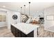 Open concept kitchen with a large island, pendant lighting, and seamless flow into the living and dining areas at 352 Dandelion Brook Ct, Las Vegas, NV 89148