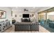 Bright living room featuring wood-look tile floors and sliding glass doors leading to outdoor living area at 352 Dandelion Brook Ct, Las Vegas, NV 89148