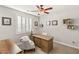 Bright home office featuring a chandelier, large window, plantation shutters and a sizable wooden desk at 352 Dandelion Brook Ct, Las Vegas, NV 89148