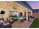 A covered patio with a ceiling fan, outdoor furniture, string lights, and a fire pit at 352 Dandelion Brook Ct, Las Vegas, NV 89148