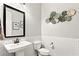 Stylish powder room featuring a pedestal sink, modern fixtures, and decorative wall accents at 352 Dandelion Brook Ct, Las Vegas, NV 89148