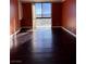 Sunlit bedroom highlighting hardwood floors and a large window with a city view at 3930 University Center Dr # 702, Las Vegas, NV 89119