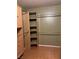 Walk-in closet with built-in shelving units and hanging rods at 3930 University Center Dr # 702, Las Vegas, NV 89119