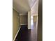 Hallway showcasing hardwood floors and leads to a bright living space with large windows at 3930 University Center Dr # 702, Las Vegas, NV 89119