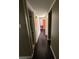 Hallway with hardwood floors leading to a full bathroom and other rooms at 3930 University Center Dr # 702, Las Vegas, NV 89119