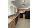 The kitchen area has a black refrigerator and stove at 3930 University Center Dr # 702, Las Vegas, NV 89119