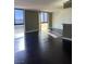 Spacious living room showcasing hardwood floors and large windows with exterior views at 3930 University Center Dr # 702, Las Vegas, NV 89119