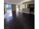 Open-concept layout featuring hardwood floors connecting living area to the kitchen at 3930 University Center Dr # 702, Las Vegas, NV 89119