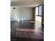 Open living area with hardwood flooring and a large window offering ample sunlight at 3930 University Center Dr # 702, Las Vegas, NV 89119