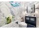 Elegant bathroom with marble walls, designer fixtures, navy vanity, and hexagon tile floor at 4140 Coneflower St, Las Vegas, NV 89135