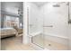 Bright bathroom boasts a walk-in shower with glass enclosure, a built-in bench, and light wood-look floors at 4140 Coneflower St, Las Vegas, NV 89135