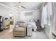 Comfortable bedroom with a recliner, mirrored dresser, ceiling fan and bright, airy feel at 4140 Coneflower St, Las Vegas, NV 89135