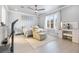 Cozy bedroom featuring a recliner, mirrored nightstands, ceiling fan and plantation shutters at 4140 Coneflower St, Las Vegas, NV 89135