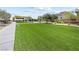 Expansive community lawn area, perfect for recreation and relaxation, within this housing development at 4140 Coneflower St, Las Vegas, NV 89135