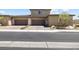 View of the home's spacious two-car garage with brick-paved driveway at 4140 Coneflower St, Las Vegas, NV 89135