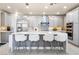 A well-lit kitchen boasts an island with seating and modern appliances at 4140 Coneflower St, Las Vegas, NV 89135
