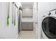 Functional laundry room with modern washer, dryer, utility sink and storage cabinets at 4140 Coneflower St, Las Vegas, NV 89135