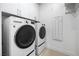 Modern laundry room with LG front-load washer and dryer and ample storage at 4140 Coneflower St, Las Vegas, NV 89135