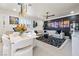 Open-concept living and dining area with stylish furniture, modern lighting, and sophisticated black and white accents at 4140 Coneflower St, Las Vegas, NV 89135