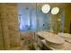 Elegant marble bathroom featuring dual sinks, a walk-in shower, and modern lighting fixtures at 4381 W Flamingo Rd # 3118, Las Vegas, NV 89103