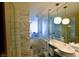 Elegant marble bathroom featuring dual sinks, a walk-in shower, and modern lighting fixtures at 4381 W Flamingo Rd # 3118, Las Vegas, NV 89103