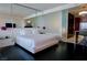 Relaxing bedroom with a king bed, mirrored wall, and modern lighting fixture at 4381 W Flamingo Rd # 3118, Las Vegas, NV 89103
