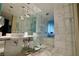 Modern bathroom with marble tiling, glass shower enclosure, and sleek fixtures at 4381 W Flamingo Rd # 3616, Las Vegas, NV 89103