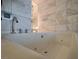Close up of a modern bathtub featuring jet tub system and view of the modern shower at 4381 W Flamingo Rd # 3616, Las Vegas, NV 89103