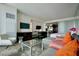 Open living space with a sleek entertainment center and partial kitchen view, bathed in natural light at 4381 W Flamingo Rd # 3616, Las Vegas, NV 89103