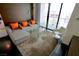 This living room features a comfortable sectional sofa, modern glass coffee table, and city views at 4381 W Flamingo Rd # 3616, Las Vegas, NV 89103