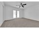 Bedroom featuring neutral carpeting, a ceiling fan, a closet with sliding doors and access to an outdoor space at 4508 Rip Van Winkle Ln, Las Vegas, NV 89102