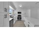 Bright kitchen featuring white cabinets, stainless steel appliances, and a center island with a quartz countertop at 4508 Rip Van Winkle Ln, Las Vegas, NV 89102
