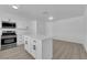 Bright kitchen featuring white cabinets, stainless steel appliances, and a center island with a quartz countertop at 4508 Rip Van Winkle Ln, Las Vegas, NV 89102