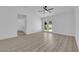 Bright living room with wood floors, ceiling fan, and glass patio doors at 4508 Rip Van Winkle Ln, Las Vegas, NV 89102