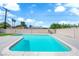 Inviting backyard pool with a tanning ledge, concrete patio, and privacy fence for fun and relaxation at 4508 Rip Van Winkle Ln, Las Vegas, NV 89102