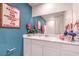 Modern bathroom with a large mirror, white cabinets, and stylish decor offering a relaxing ambiance at 48344 Orchid Ridge Ave # 104, Las Vegas, NV 89141