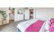 Bedroom with plush bedding, dresser, and access to bathroom and living room at 48344 Orchid Ridge Ave # 104, Las Vegas, NV 89141