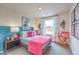 Charming bedroom with modern accents, unique artwork, and a cozy, colorful bed at 48344 Orchid Ridge Ave # 104, Las Vegas, NV 89141