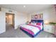 Comfortable bedroom with stylish decor, closet, and access to other areas at 48344 Orchid Ridge Ave # 104, Las Vegas, NV 89141