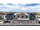 Modern townhome with attached garages, stylish exterior paint scheme, and community amenities at 48344 Orchid Ridge Ave # 104, Las Vegas, NV 89141
