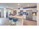Well-lit kitchen with stainless steel appliances, island seating, and modern finishes at 48344 Orchid Ridge Ave # 104, Las Vegas, NV 89141