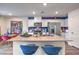 Modern kitchen with white cabinets, stainless steel appliances, and a central island at 48344 Orchid Ridge Ave # 104, Las Vegas, NV 89141