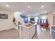 Stylish kitchen with stainless appliances, island with bar, and view of dining area and living room at 48344 Orchid Ridge Ave # 104, Las Vegas, NV 89141
