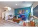 Cozy living room with a staircase, featuring contemporary furniture and a colorful rug at 48344 Orchid Ridge Ave # 104, Las Vegas, NV 89141