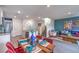 Open-concept living space with stairs, dining, and comfortable seating arrangement at 48344 Orchid Ridge Ave # 104, Las Vegas, NV 89141