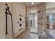 Modern bathroom showcasing a luxurious walk-in shower with multiple shower heads and a built-in bench at 5079 Mountain Top Cir, Las Vegas, NV 89148